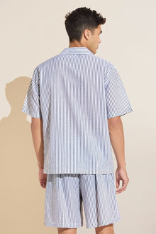 Model wears Men's Organic Sandwashed Cotton Short PJ Set in Nautico Stripe Graphite.