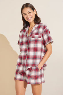 Model wears Flannel Short PJ Set in red and ivory plaid.