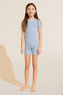 Model wears Kids Printed TENCEL™ Modal Unisex Short PJ Set in double diamond denim blue.