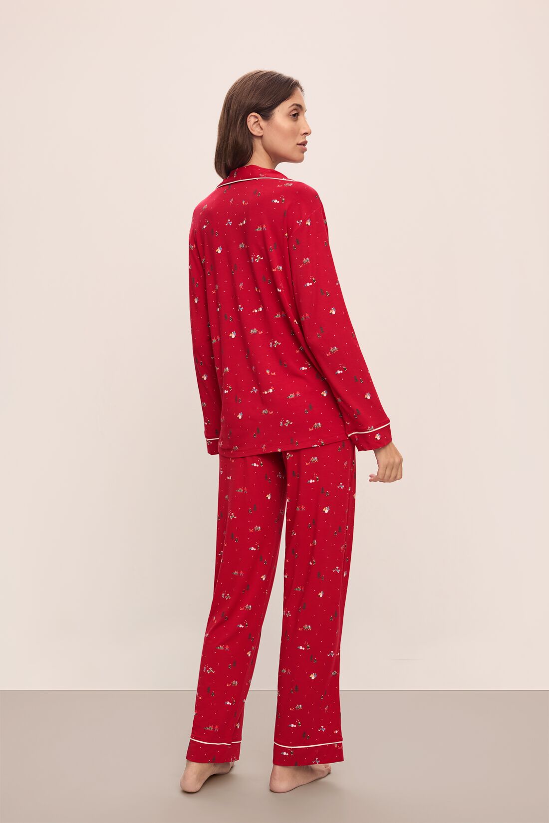 Model wears the Gisele Printed TENCELâ„¢ Modal Long PJ Set in Winter Wonderland Haute Red/Ivory.