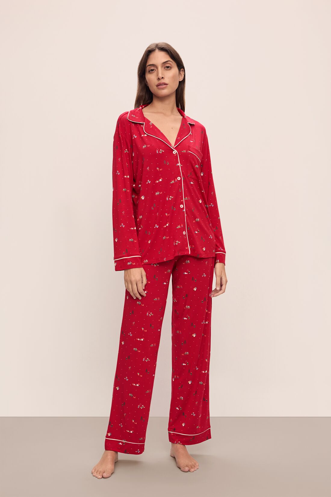 Model wears the Gisele Printed TENCELâ„¢ Modal Long PJ Set in Winter Wonderland Haute Red/Ivory.