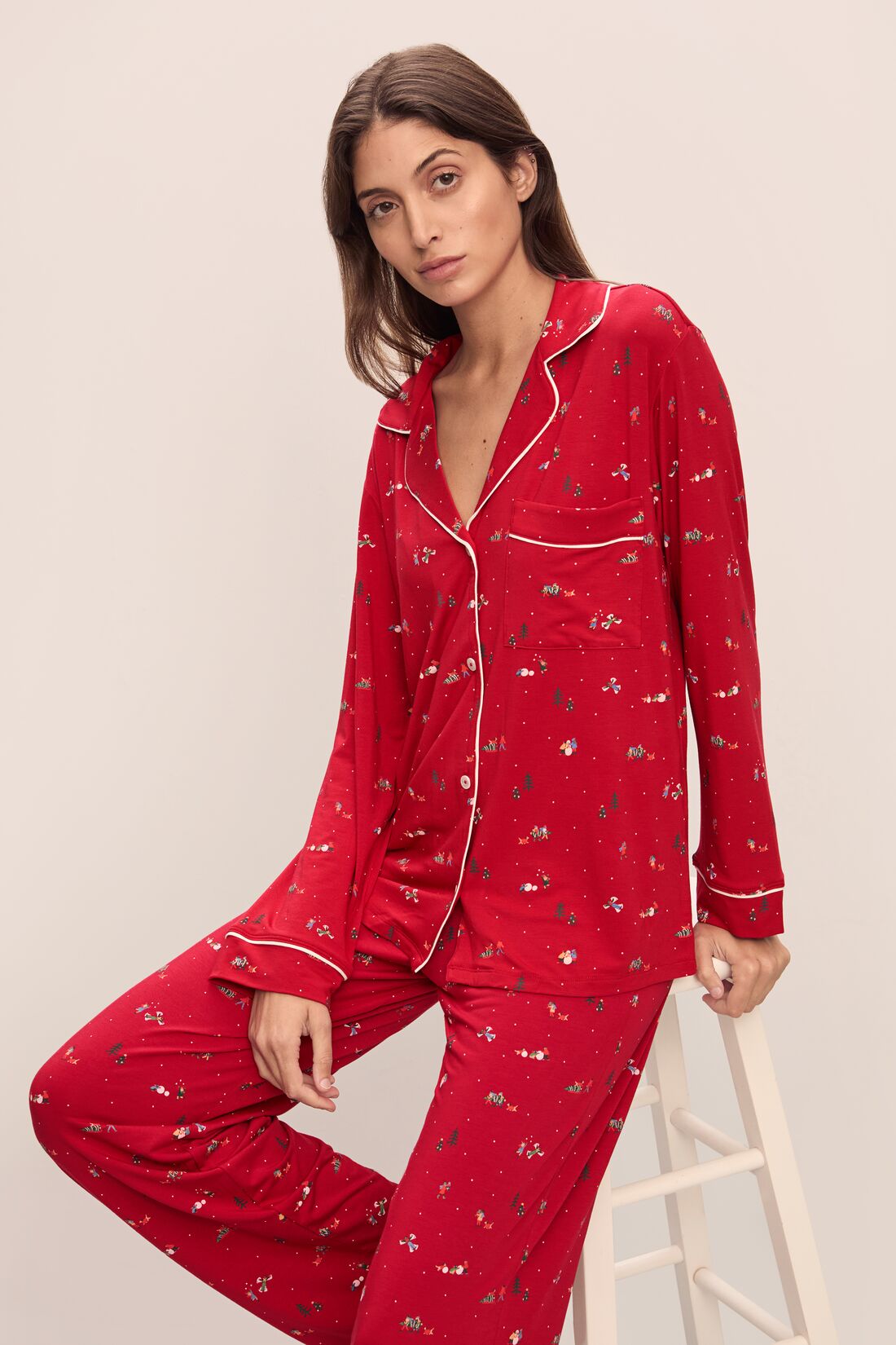 Model wears the Gisele Printed TENCELâ„¢ Modal Long PJ Set in Winter Wonderland Haute Red/Ivory.