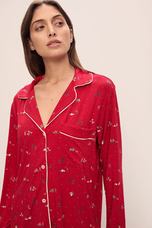 Model wears the Gisele Printed TENCELâ„¢ Modal Long PJ Set in Winter Wonderland Haute Red/Ivory.
