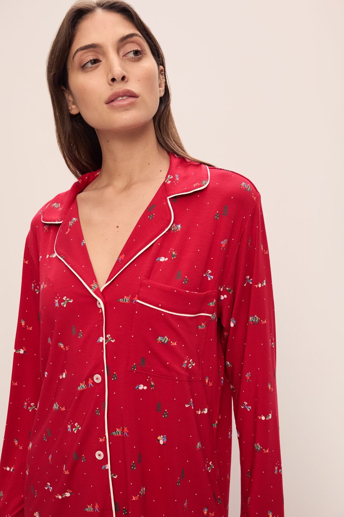 Model wears the Gisele Printed TENCELâ„¢ Modal Long PJ Set in Winter Wonderland Haute Red/Ivory.