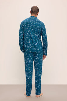 Model wears William Printed TENCELâ„¢ Modal Long PJ Set in Festive Lights Sapphire/Ivory.