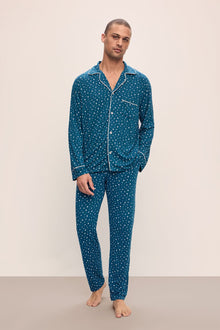Model wears William Printed TENCELâ„¢ Modal Long PJ Set in Festive Lights Sapphire/Ivory.