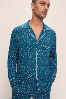 Model wears William Printed TENCELâ„¢ Modal Long PJ Set in Festive Lights Sapphire/Ivory.