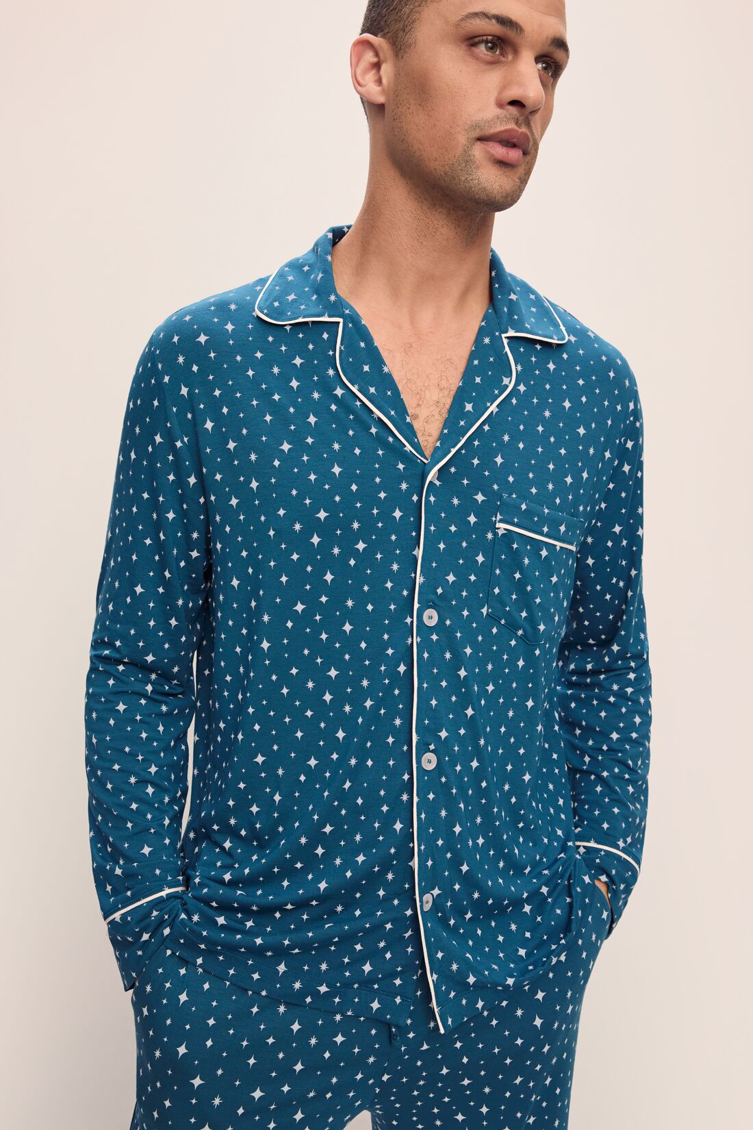 Model wears William Printed TENCELâ„¢ Modal Long PJ Set in Festive Lights Sapphire/Ivory.