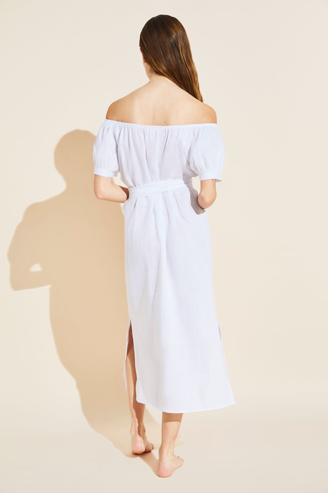 Model wears Harper Linen Dress in white.