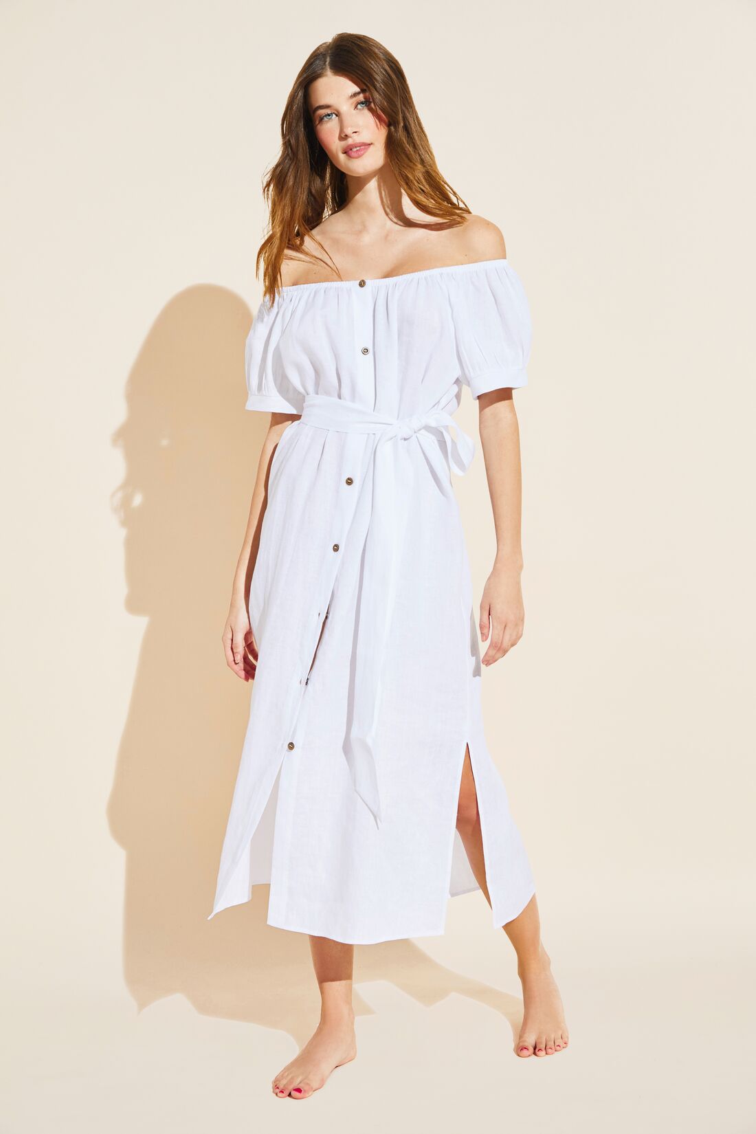 Model wears Harper Linen Dress in white.