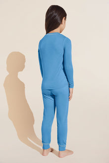 Model wears Kids TENCEL™ Modal Unisex Long PJ Set in Azure/Ivory.