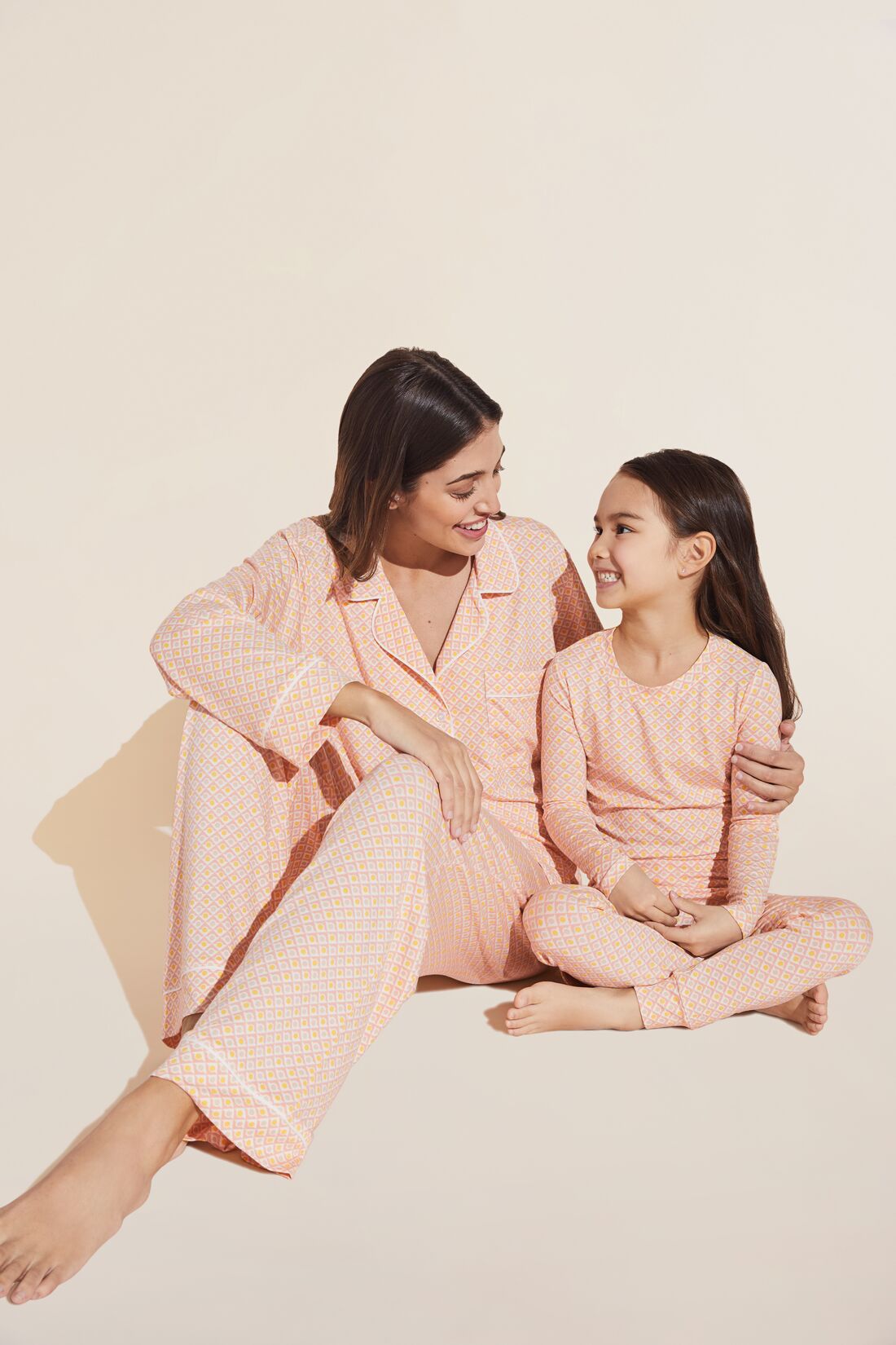 Model wears Kids Printed TENCEL™ Modal Unisex Long PJ Set in geo rose cloud.