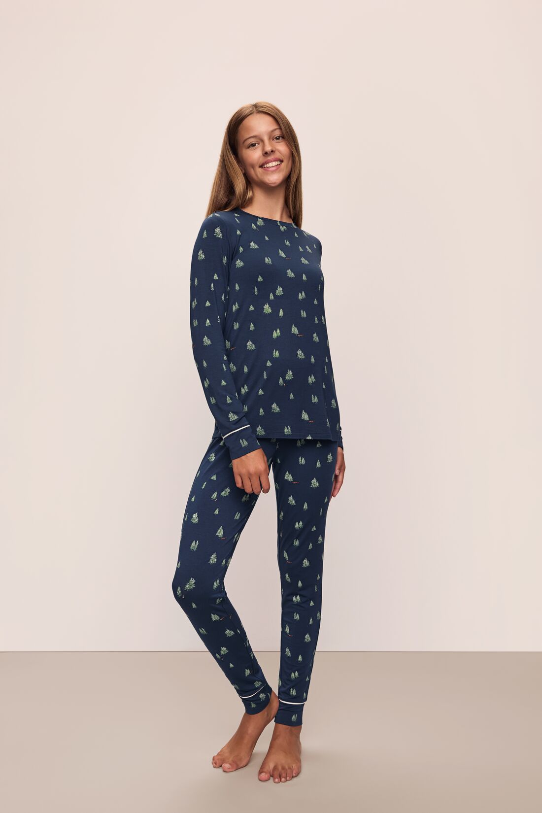 Model wears the Gisele Printed TENCELâ„¢ Modal Crewneck PJ Set in Woodland Pine Navy/Ivory.