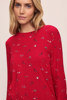 Model wears the Gisele Printed TENCELâ„¢ Modal Crewneck PJ Set in Winter Wonderland Haute Red/Ivory.