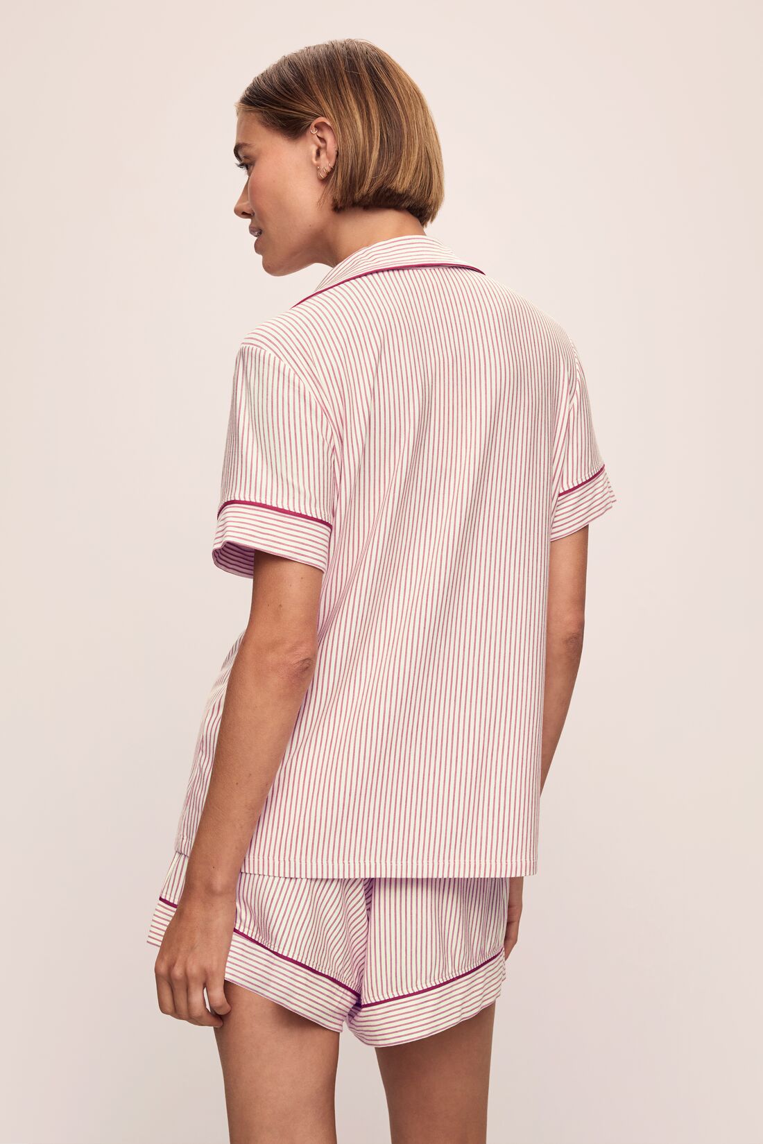 Model wears the Gisele Printed TENCELâ„¢ Modal Relaxed Short PJ Set in Duo Stripe Haute Red/Haute Red.