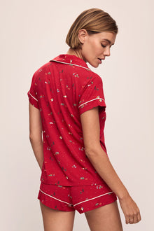Model wears the Gisele Printed TENCELâ„¢ Modal Shortie Short PJ Set in Winter Wonderland Haute Red/Ivory.