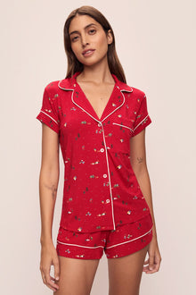 Model wears the Gisele Printed TENCELâ„¢ Modal Shortie Short PJ Set in Winter Wonderland Haute Red/Ivory.