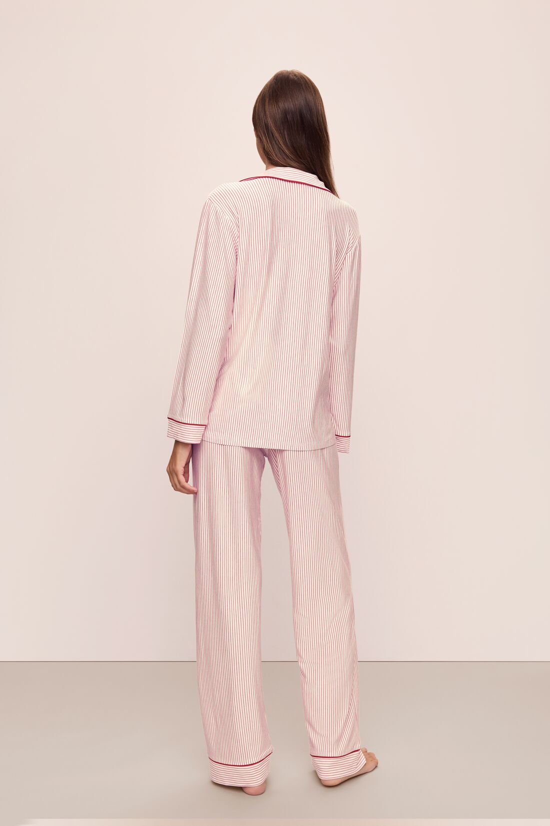 Model wears the Gisele Printed TENCELâ„¢ Modal Long PJ Set in Duo Stripe Haute Red/Haute Red.