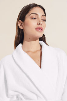 Model wears Terry Gender Neutral Robe in white.