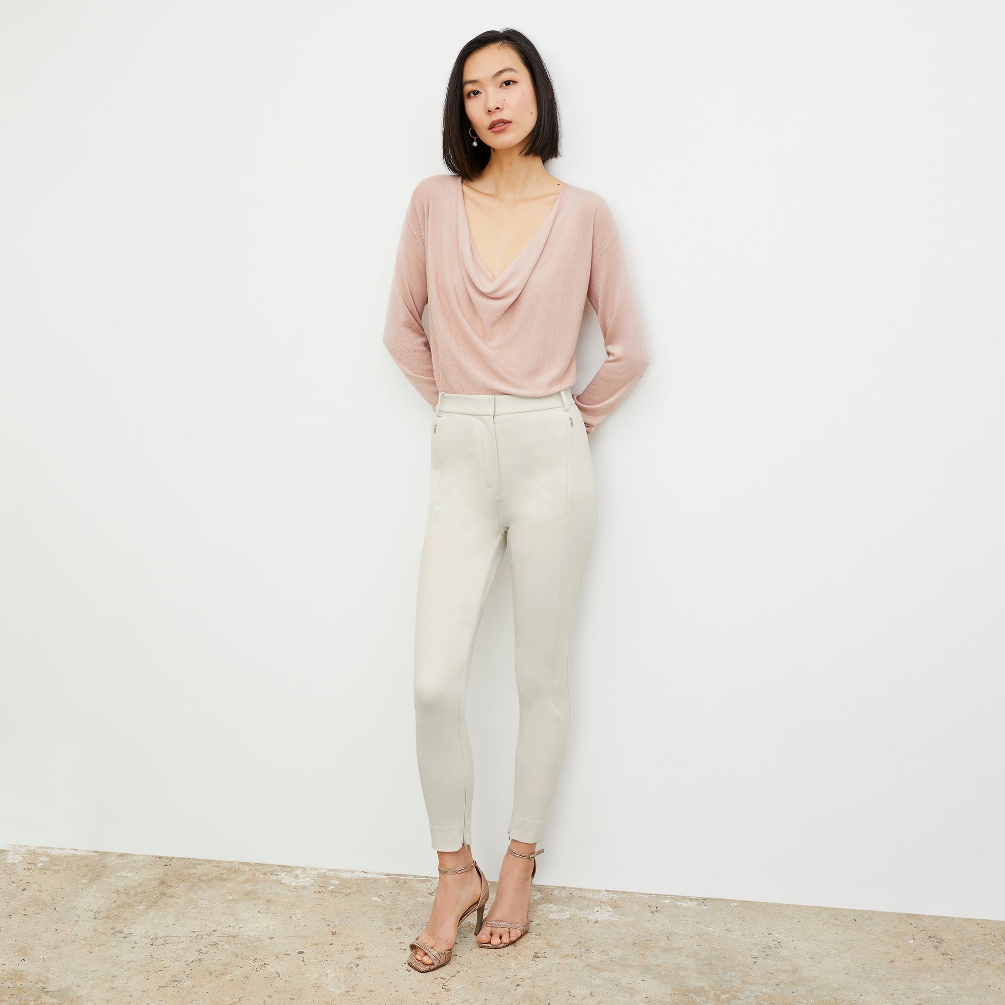 Front image of a woman standing wearing the Curie Pant—Everstretch in Bone | Exclude