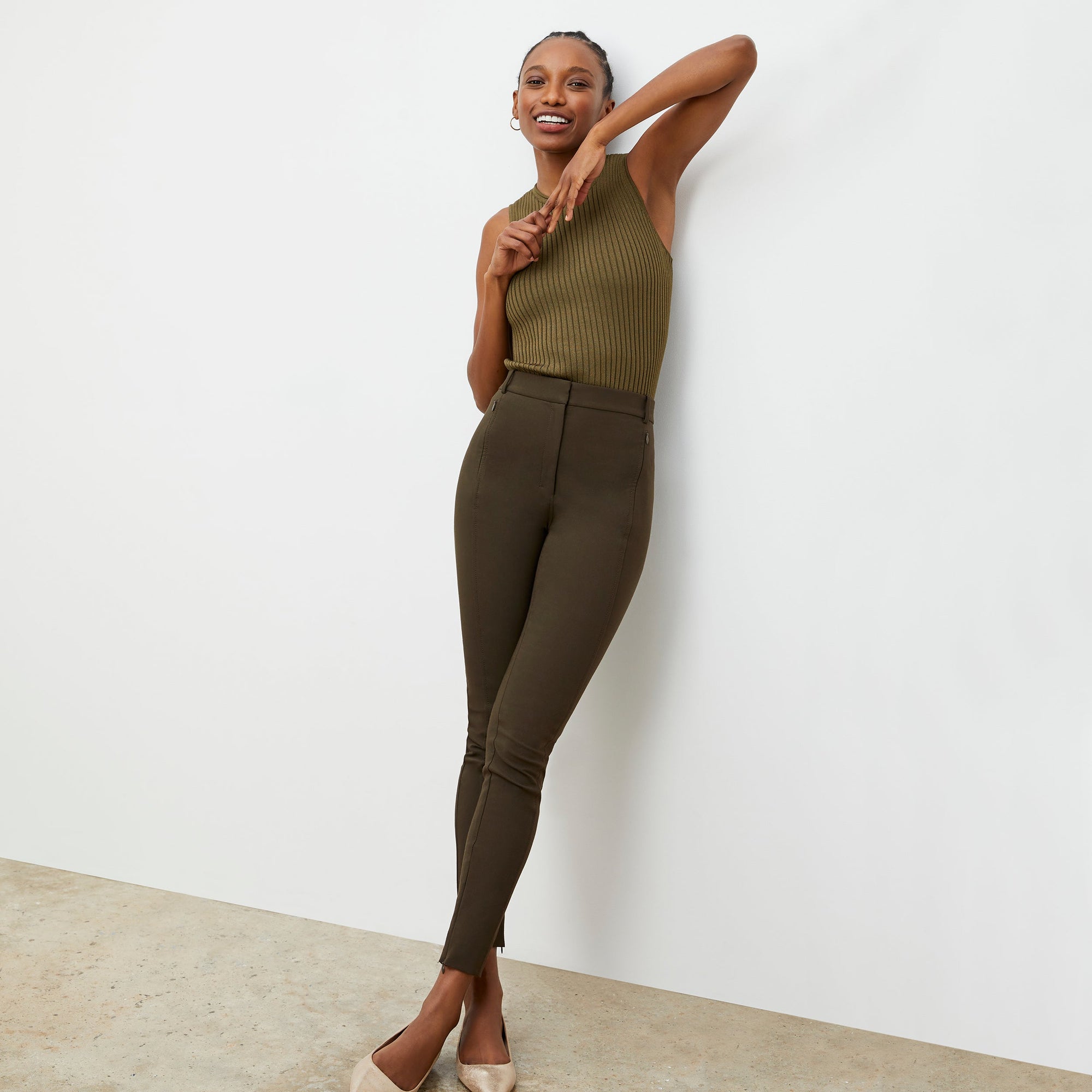 Front image of a woman standing wearing the curie pant in dark olive