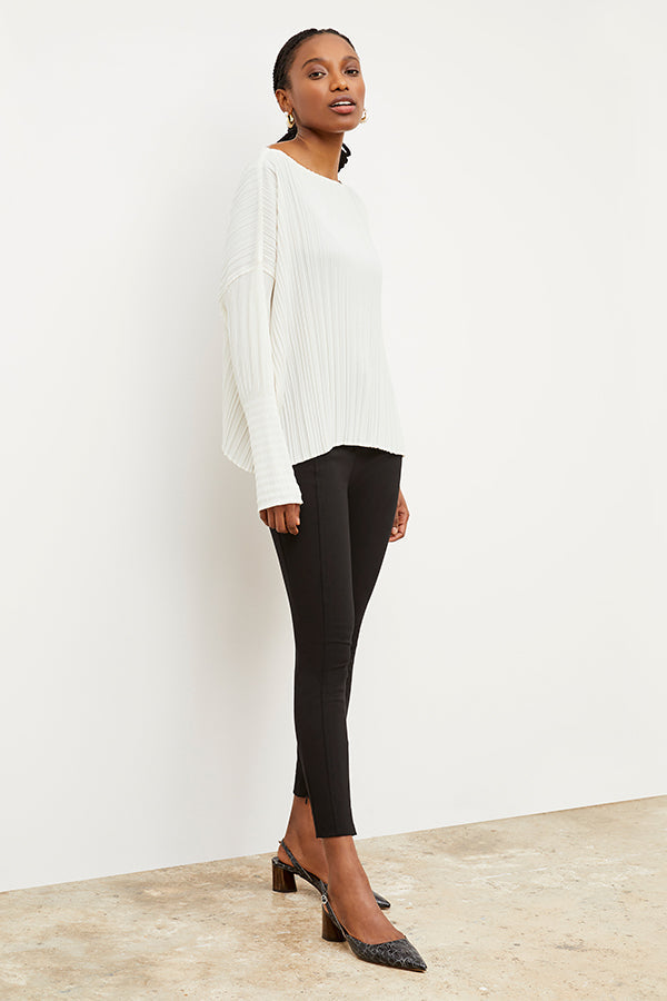 Front image of a woman standing wearing the curie pant in black | Exclude