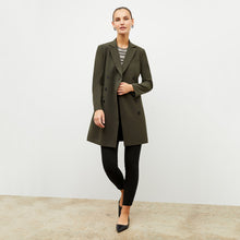 Front image of a woman wearing the gwynne dress in olive