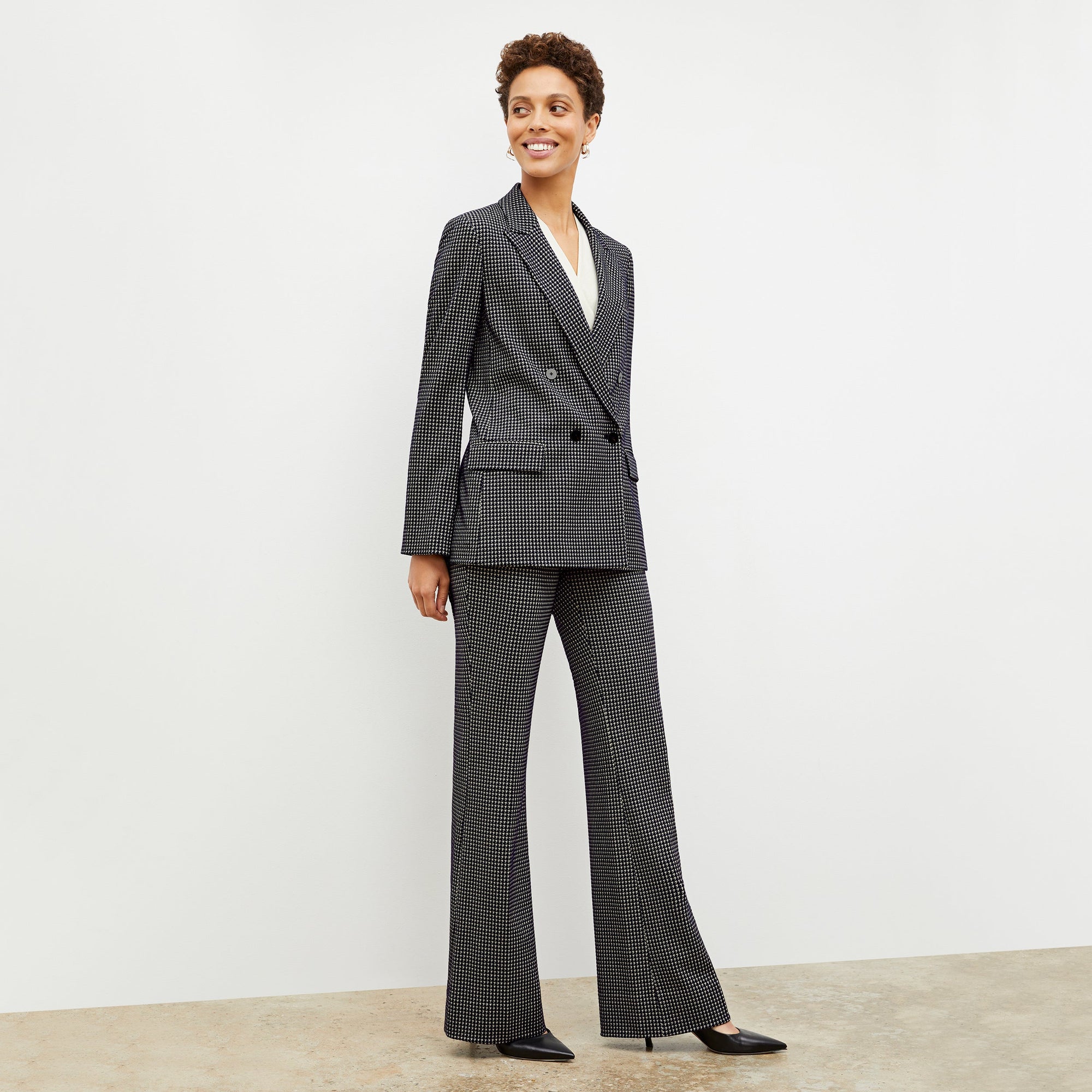 Front image of a woman wearing the horton pant in black and white houndstooth | Lead