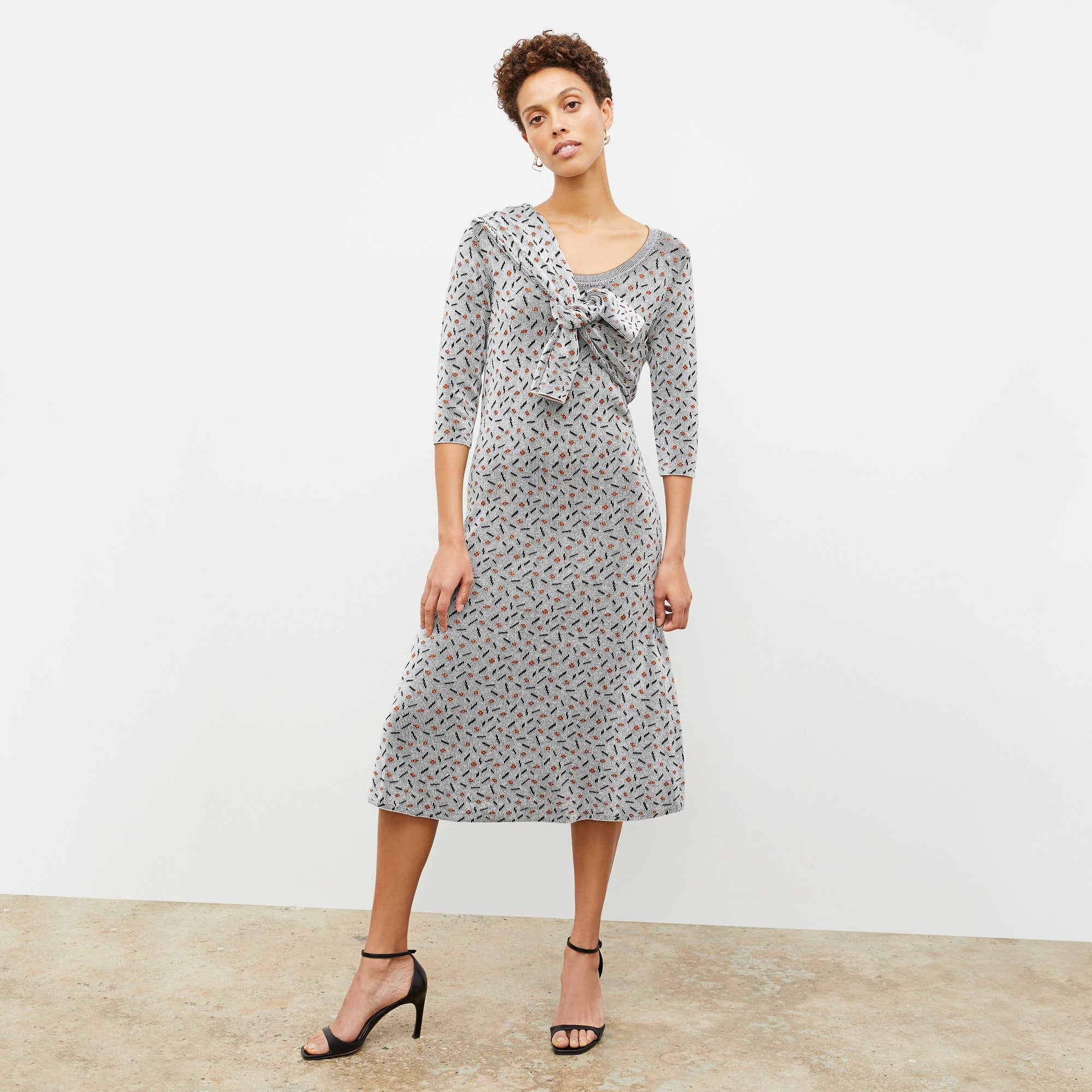 Front image of a woman wearing the Tippy Dress in Brick and Black | Lead 