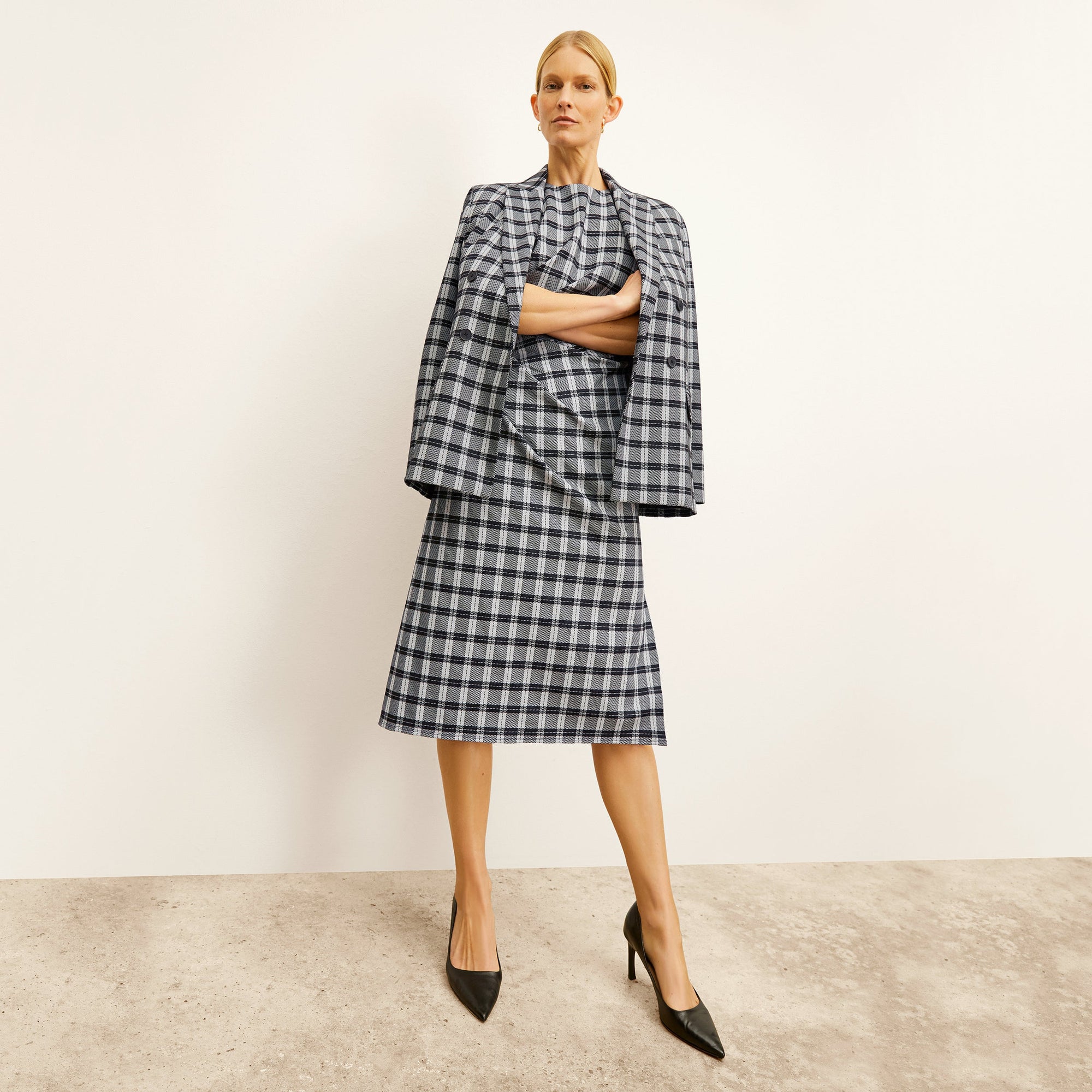 front image of a woman wearing the jeannine dress in checkmate
