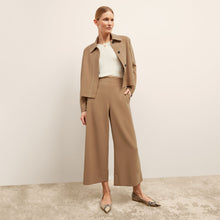 front image of a woman wearing the nicky jacket in saddle