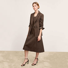 Front image of a woman wearing the Tyner jacket in stretch chino in date