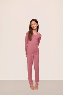 Model is wearing Kids TENCEL Modal Unisex Long PJ Set  in  Berry Blush/Ivory