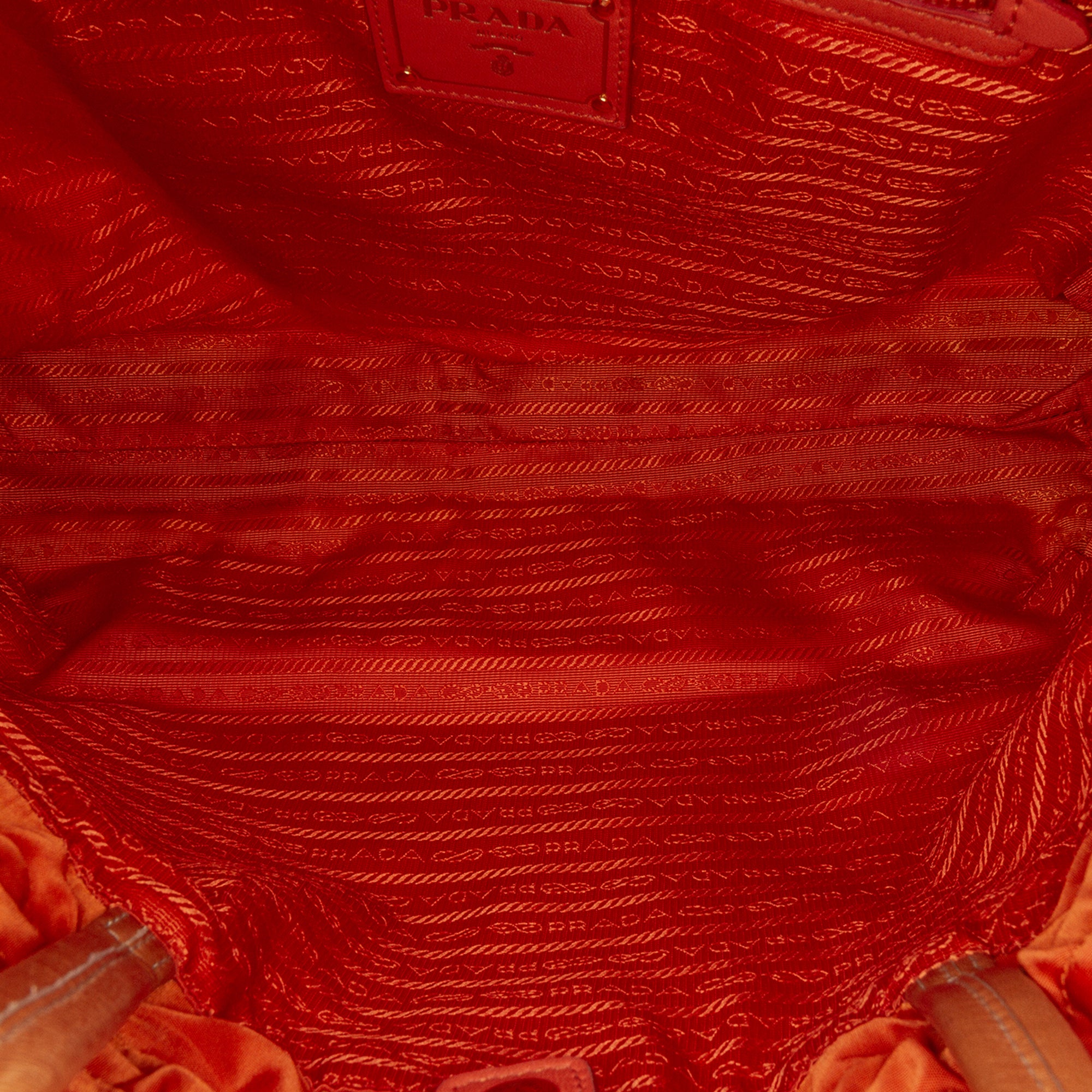 Prada | Pre-Owned Tessuto Logo Drawstring Tote | Orange