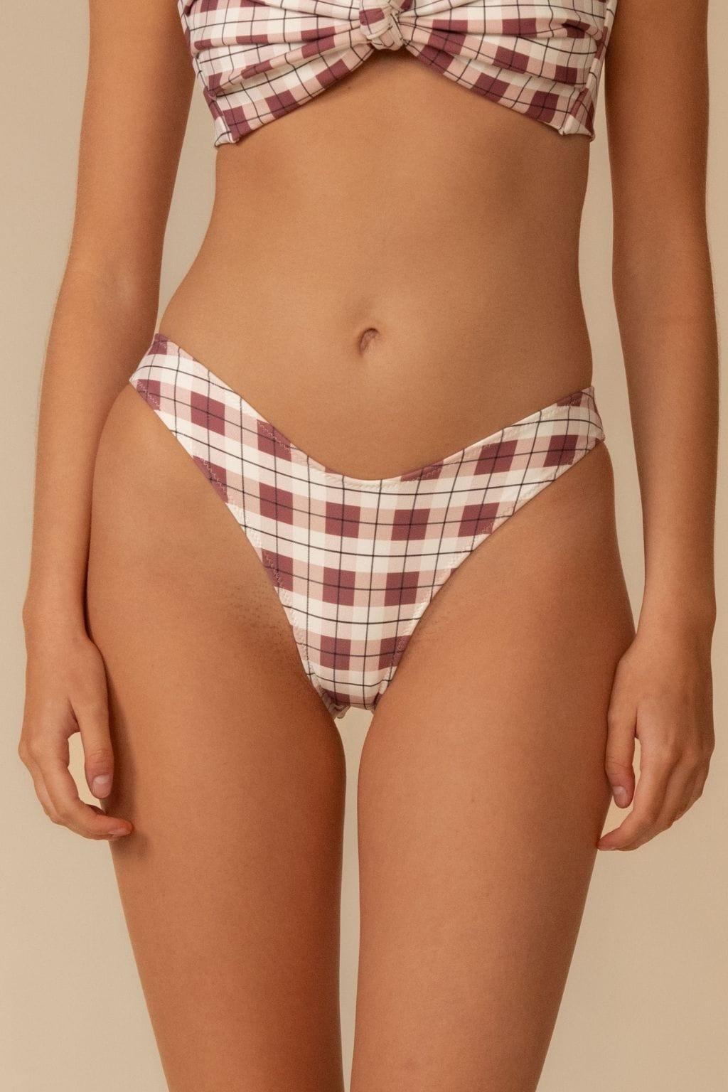 Maroon and cream plaid bikini bottom with curved waistband and diamond pattern design.
