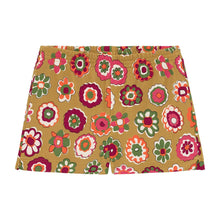 Tan swim trunk with multicolored floral print featuring pink, red, green, and white flowers throughout.