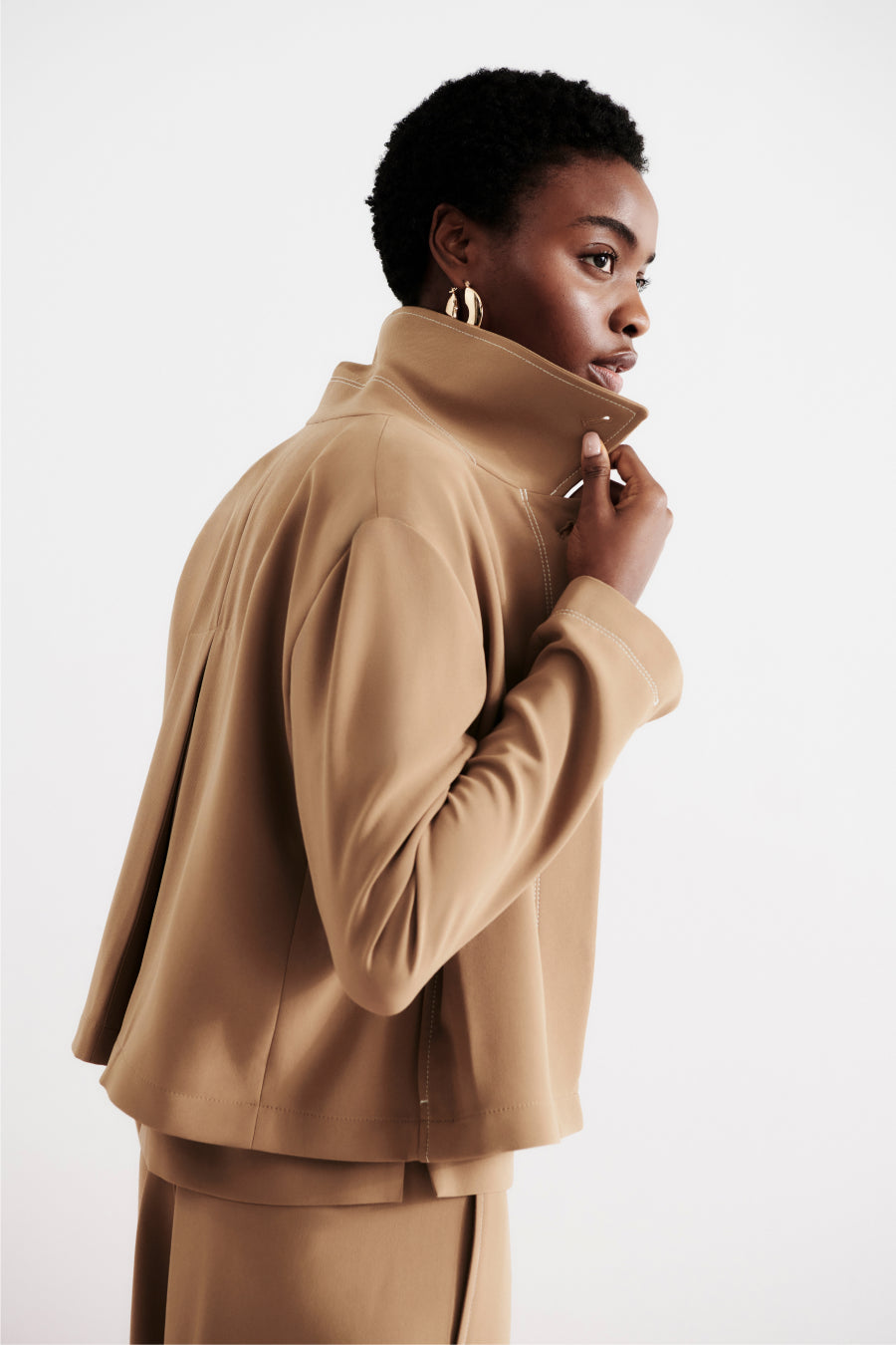 front image of a woman wearing the nicky jacket in saddle | Exclude
