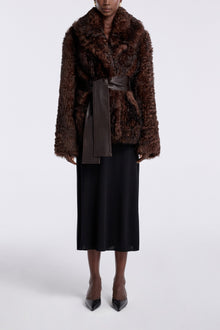 Model is wearing the Nour Hammour Noa Curled Shearling Coat Bourbon - Front Closed