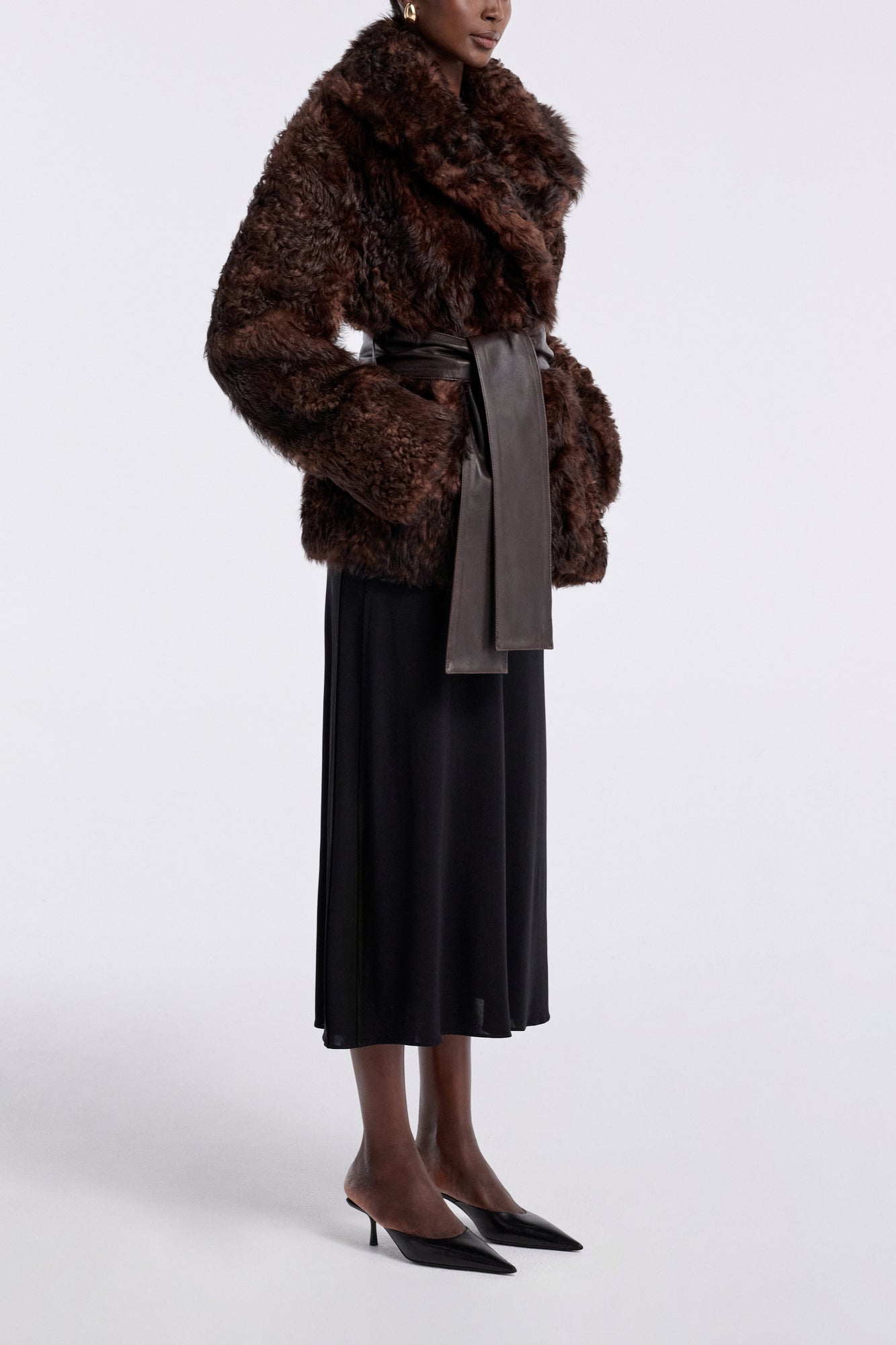 Model is wearing the Nour Hammour Noa Curled Shearling Coat Bourbon - Three Quarters
