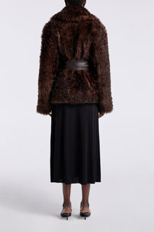 Model is wearing the Nour Hammour Noa Curled Shearling Coat Bourbon - Back