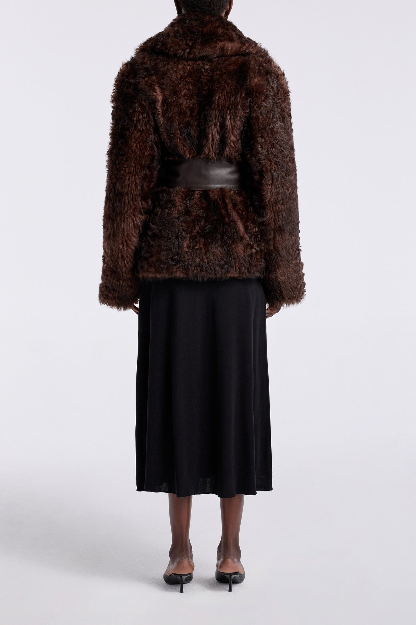 Model is wearing the Nour Hammour Noa Curled Shearling Coat Bourbon - Back