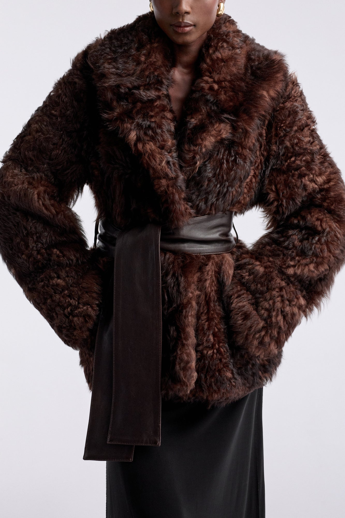 Model is wearing the Nour Hammour Noa Curled Shearling Coat Bourbon - Detail