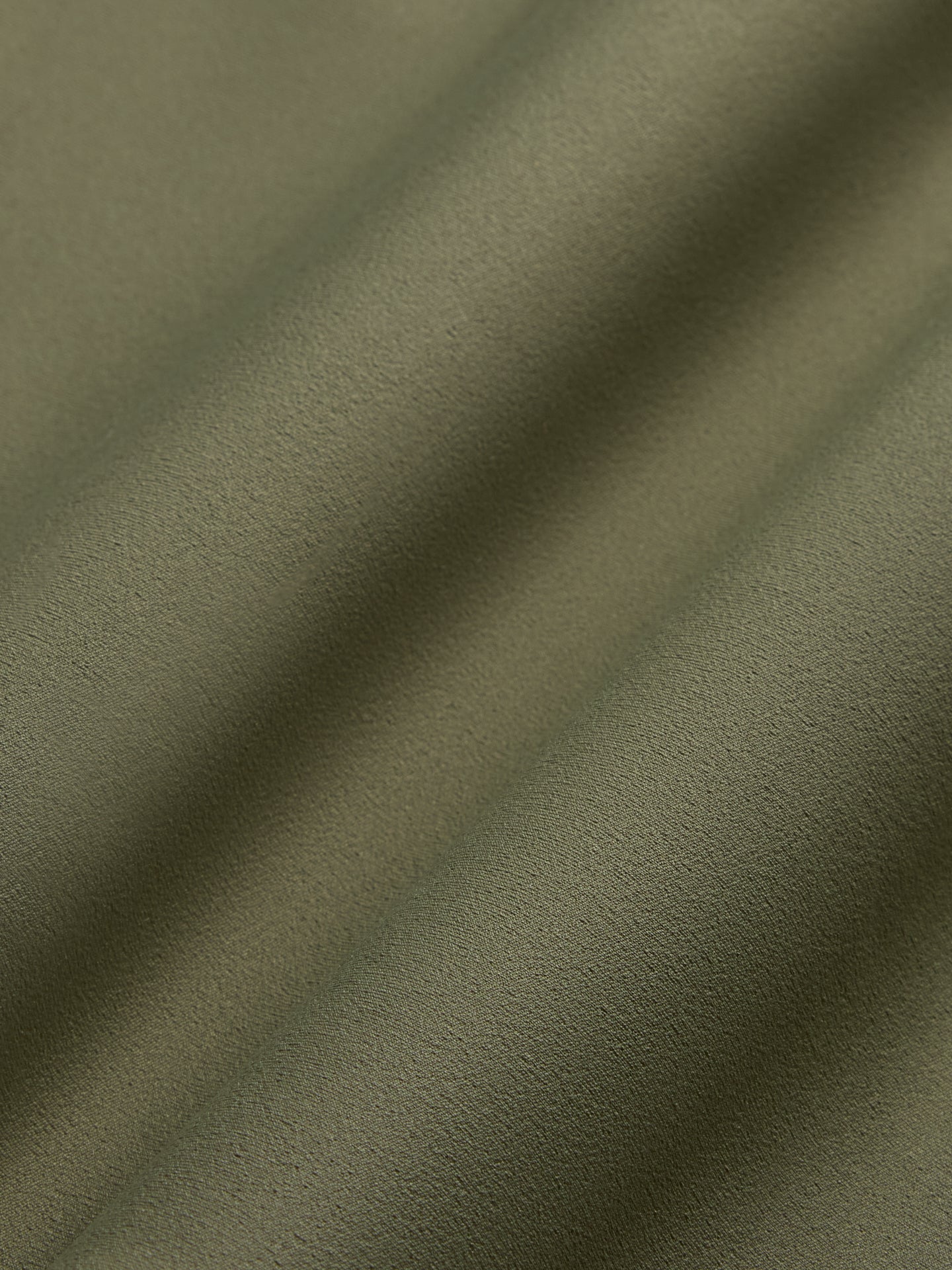 Close-up of olive Diamond Compression fabric texture.