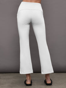 Back view of white flare pants with high waistband and flare hem.