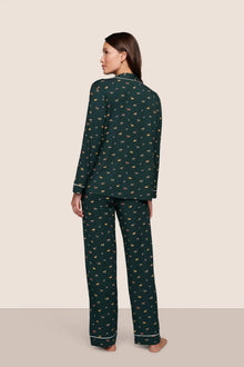 Model is wearing Gisele Printed TENCEL Modal Long PJ Set  in Holiday Dogs Pine/Ivory