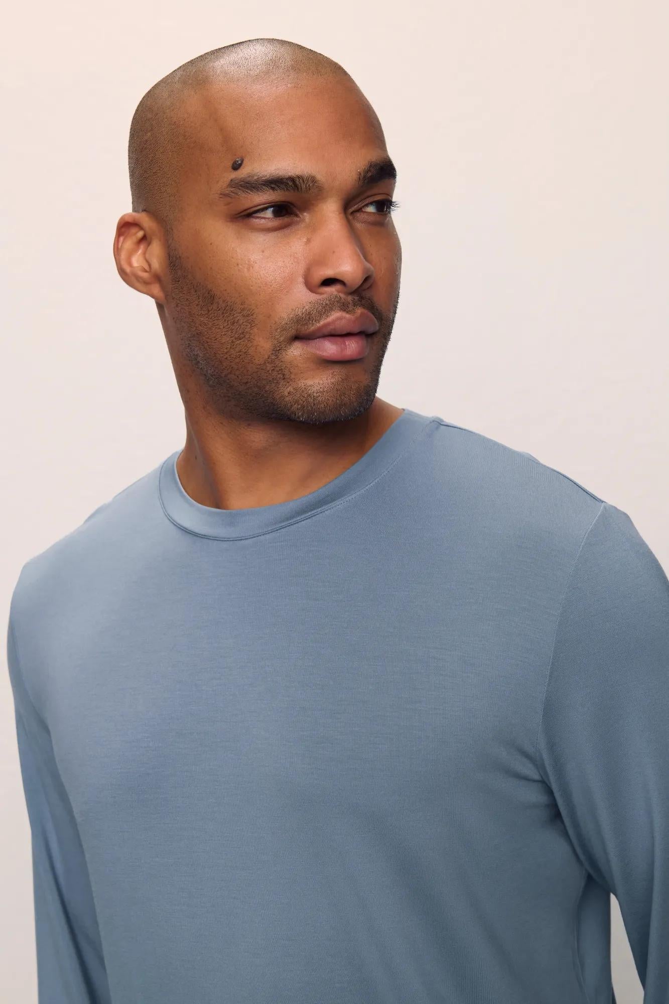 Model is wearing Henry TENCEL Modal Long Sleeve Crew PJ Set in Faded Denim