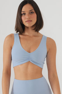 Light blue ribbed bikini top with V-neckline and twisted front detail.