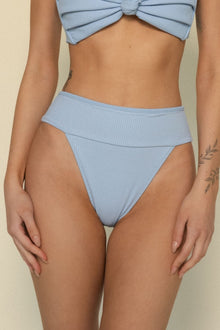 Light blue ribbed bikini bottom with folded waistband detail on model.