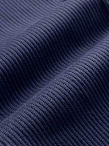Close-up of ribbed Melt fabric texture in true navy.