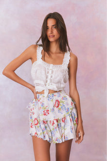 White floral tiered ruffle skirt with red, green, and blue accents with elastic waistband and double lined.